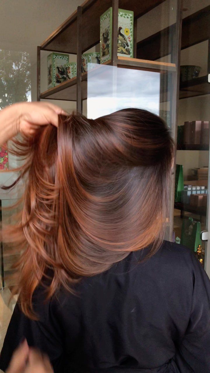 Long chocolate brown hair with flowing warm copper highlights