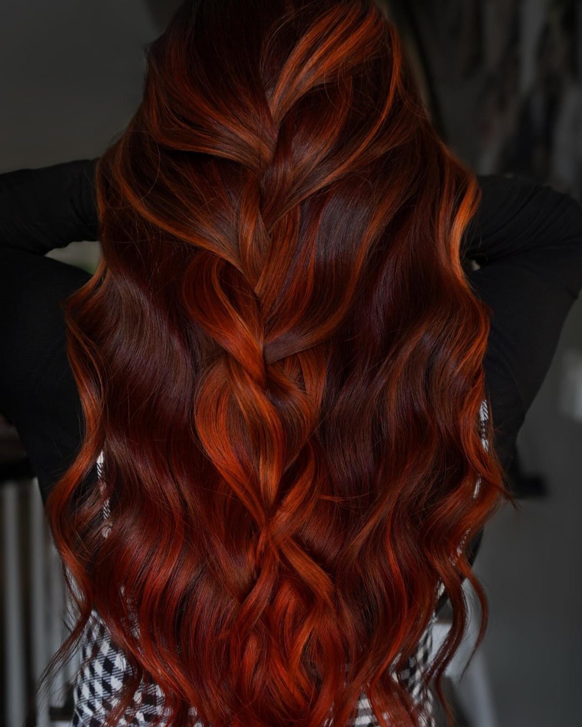 Long wavy brunette hair with dark copper highlights and glossy curls