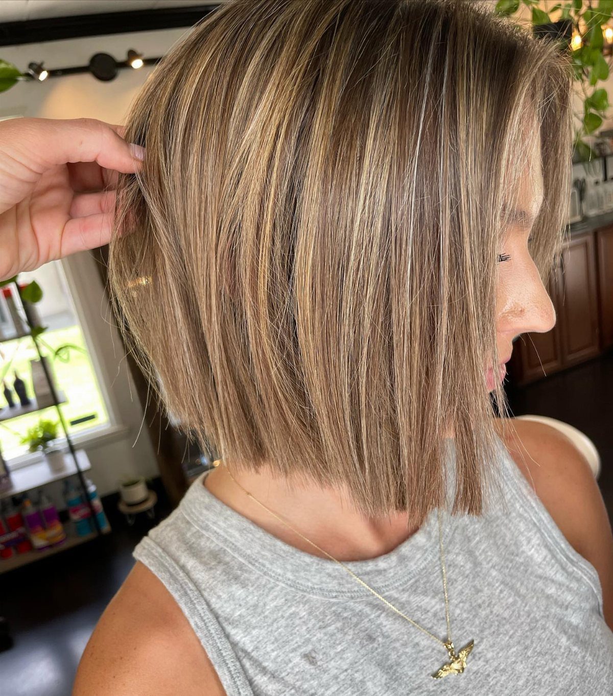 Inverted bob with pale blonde streaks over a darker caramel base