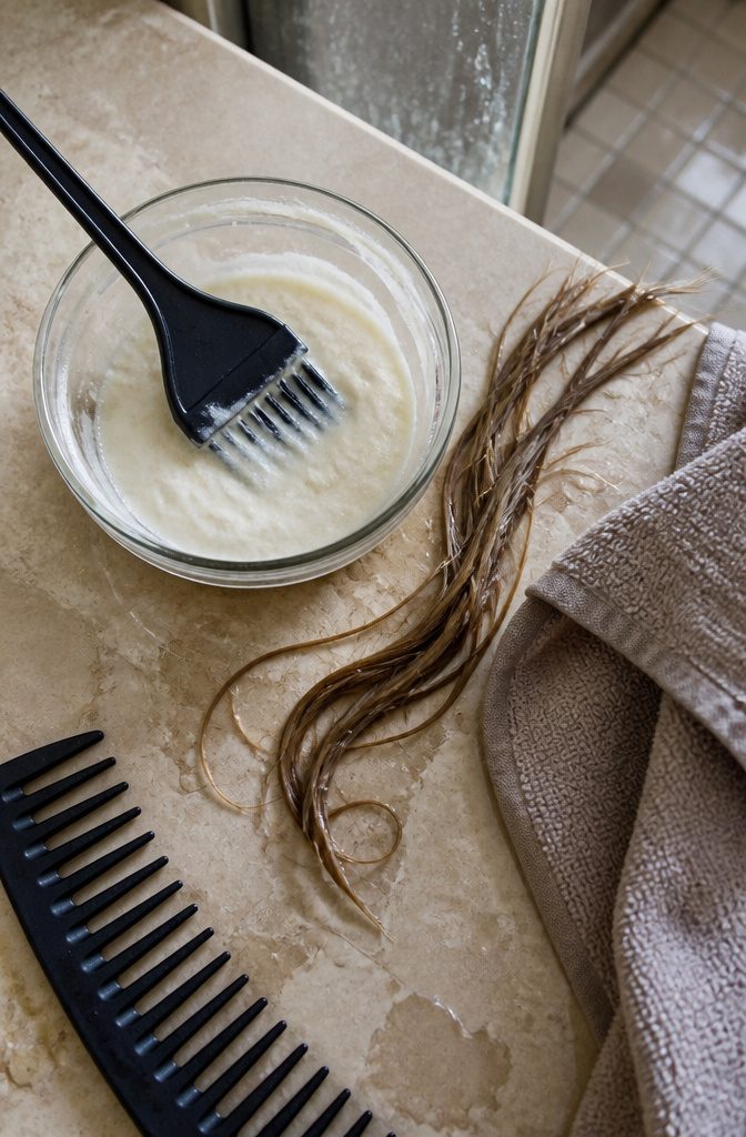 Baking soda and shampoo arranged beside a bowl for mixing