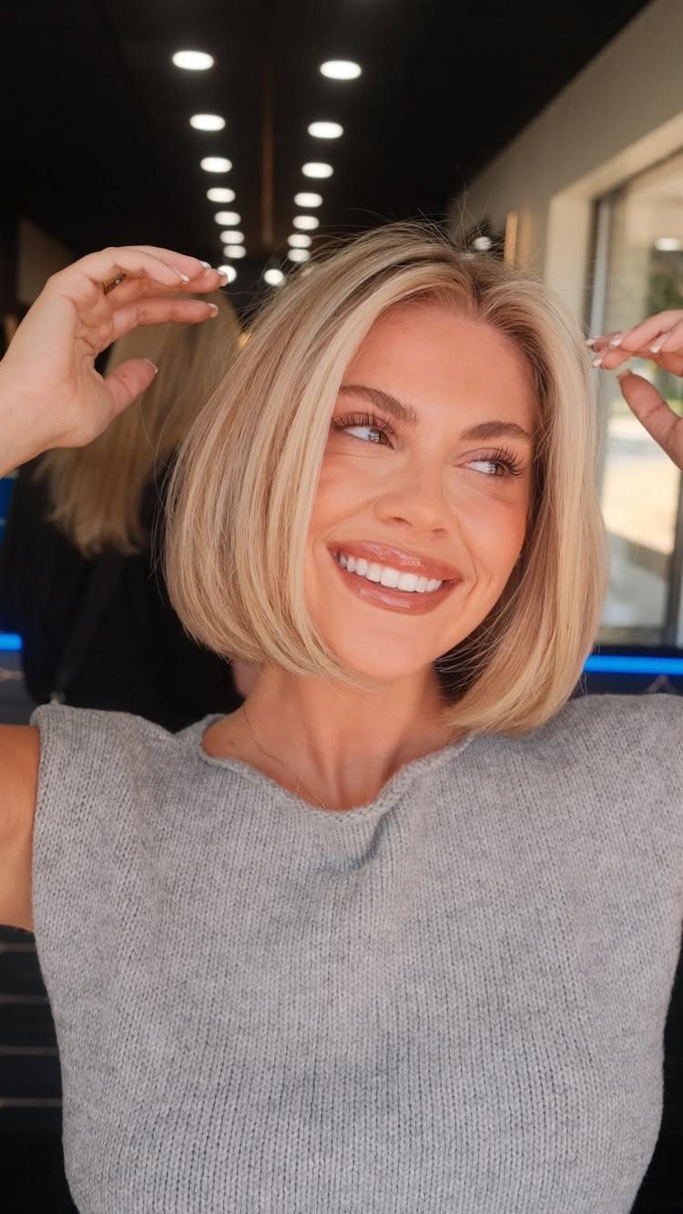 Woman with a chin-length blonde bob showing subtle darker lowlights
