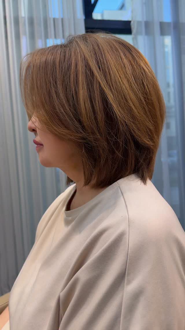 Light brown bob with blended blonde and brown tones, viewed in profile