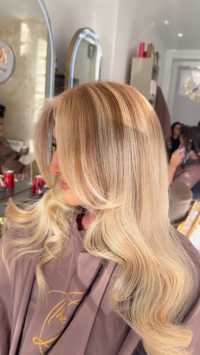 Long blonde hair with beige lowlights styled in loose curls