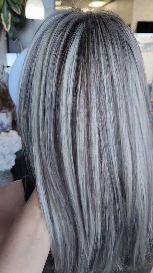 Platinum shoulder-length hair with ash-gray lowlights in a salon