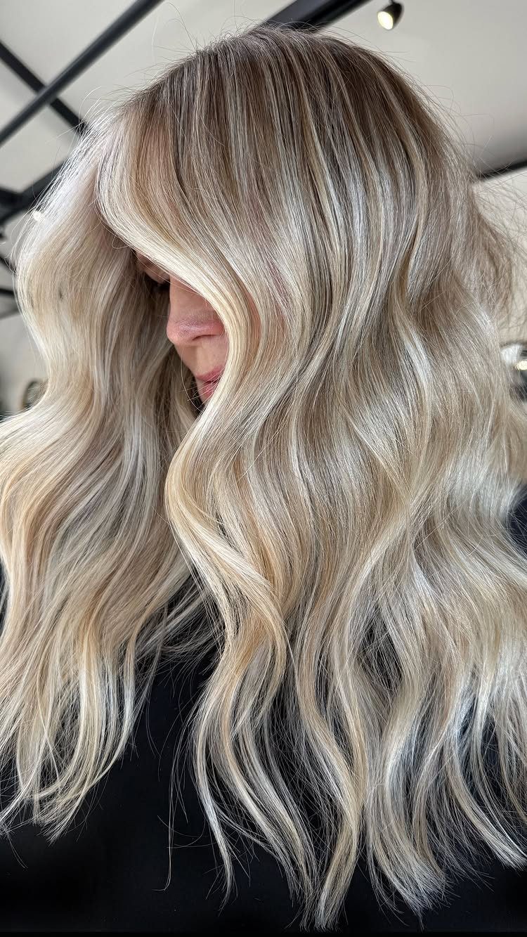 Long wavy brown hair with softly blended blonde balayage highlights