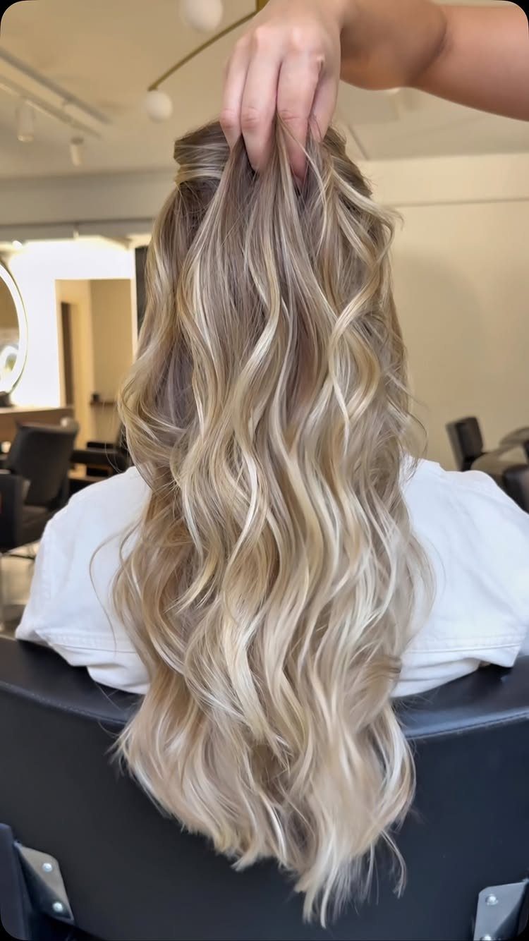 Long wavy brown hair with softly warm-neutral champagne blonde highlights