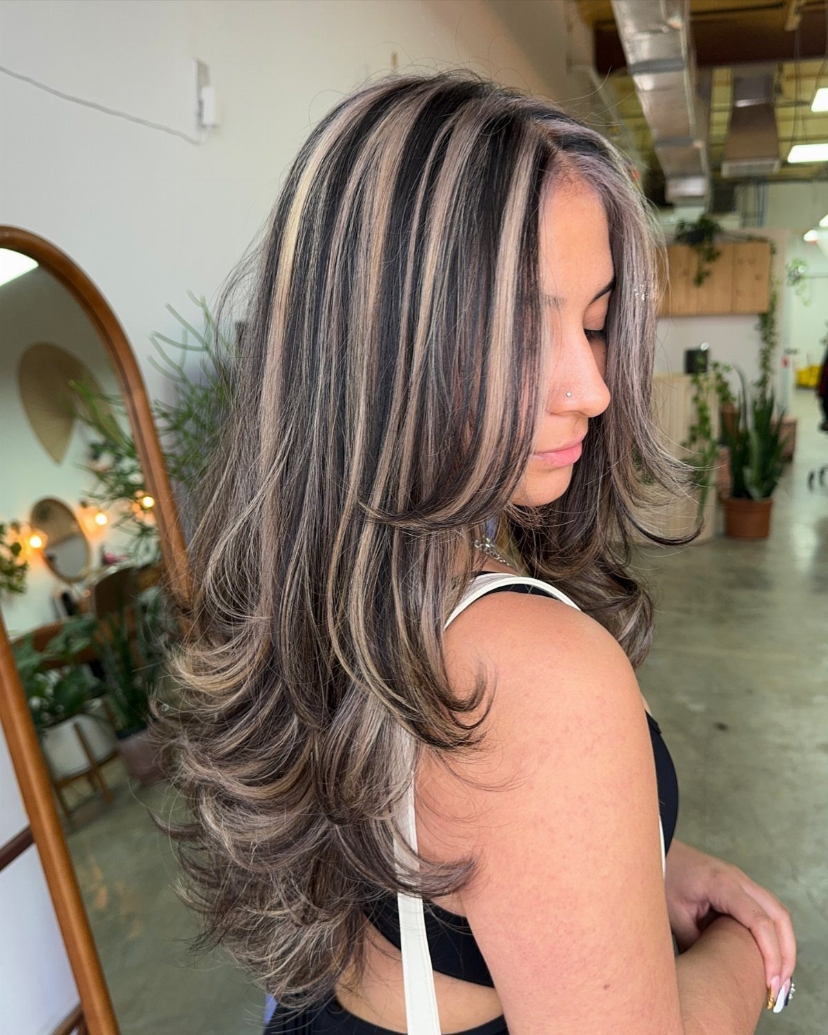 Woman showing layered brown hair with bold, wide blonde highlights