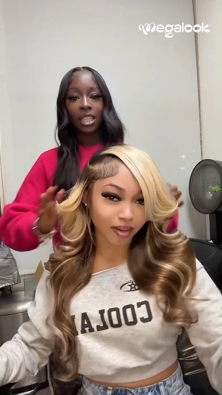 Long brown waves with broad blonde highlights styled around a seated woman's face