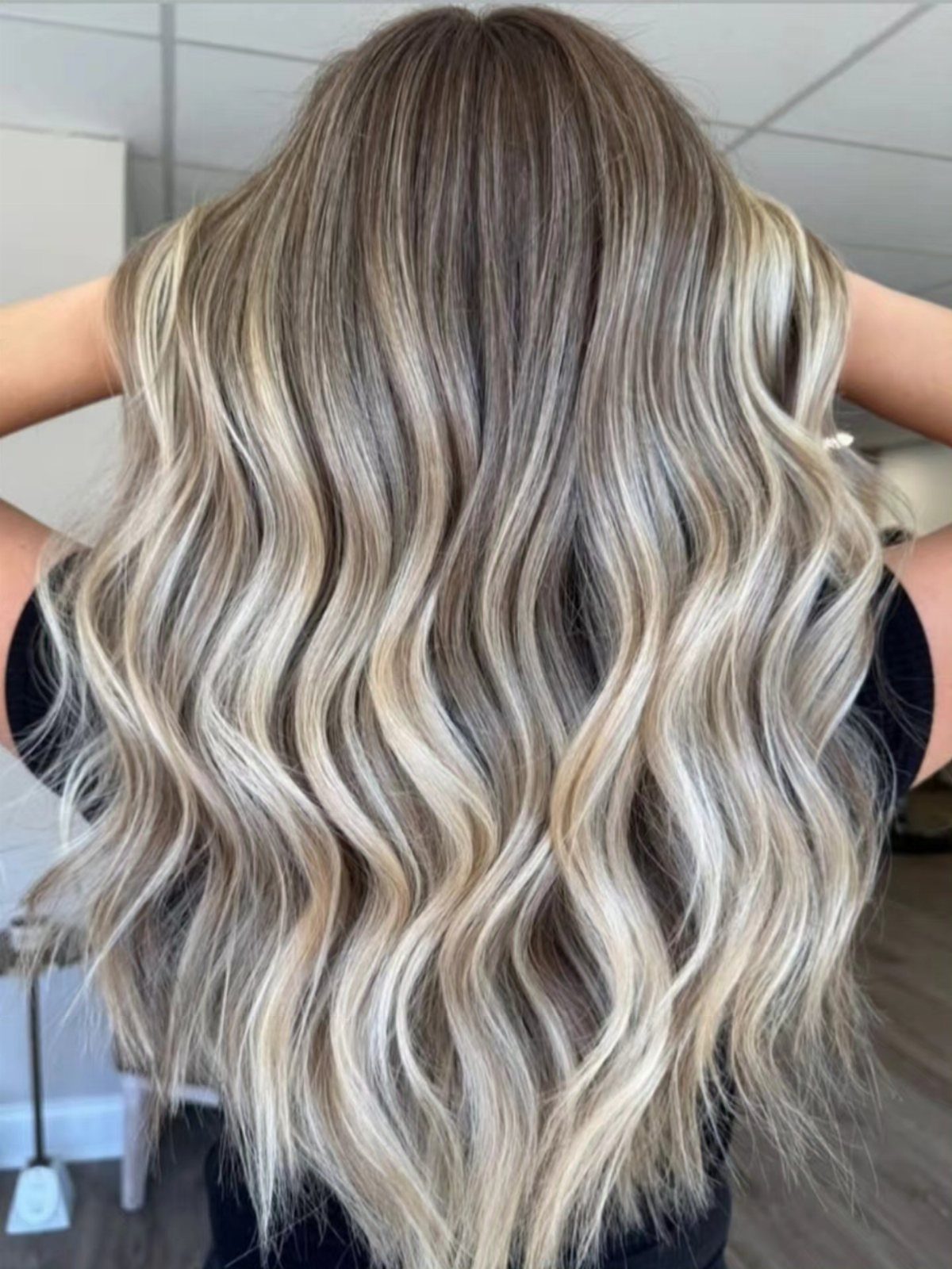 Wavy dishwater-blonde hair transitions into bright platinum lengths and ends