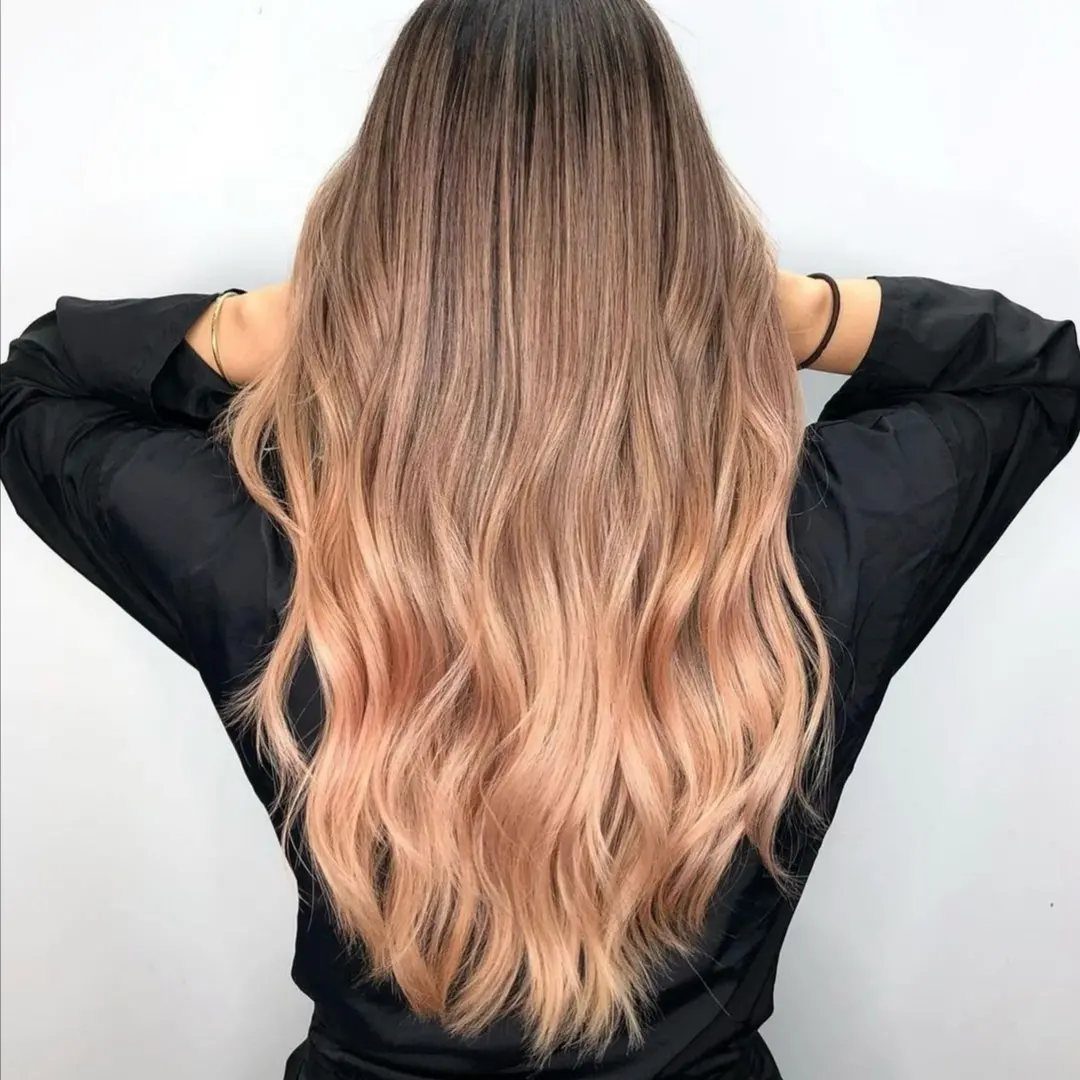 Long wavy brown hair melting into dusty rose and peachy pink lengths