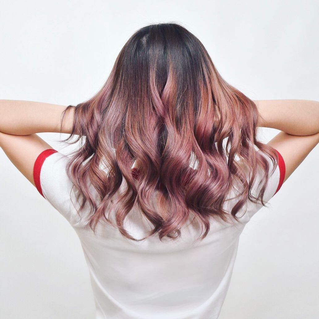 Wavy brown hair blending into dusty rose and blonde lengths