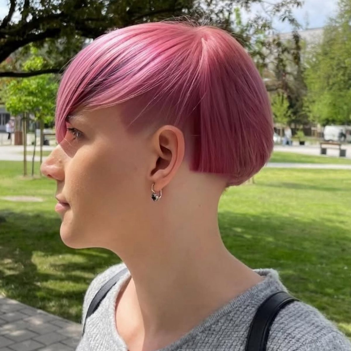 Magenta bowl cut with smooth rounded hair and a long side fringe