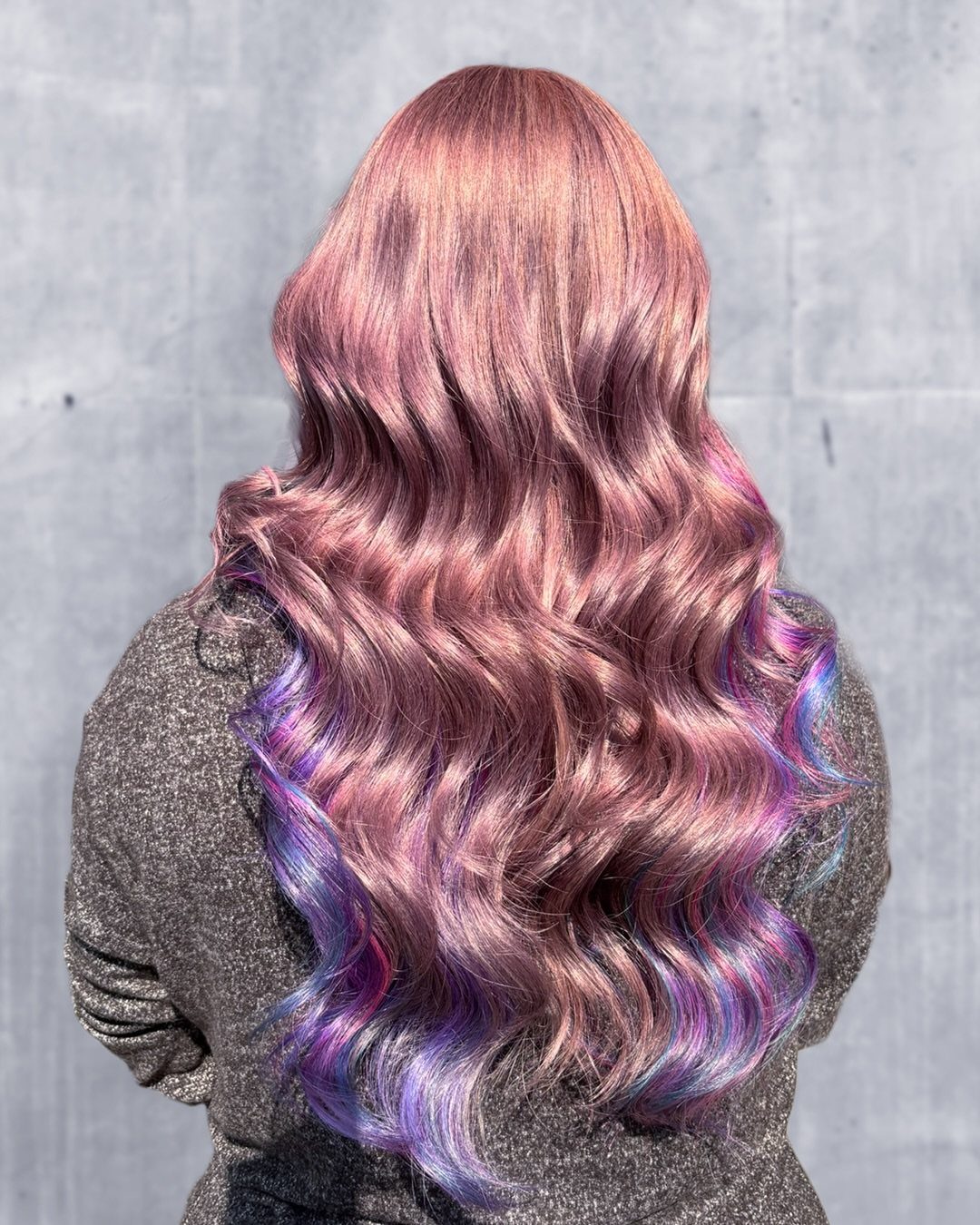 Wavy hair melts from dusty rose into pastel purple and blue