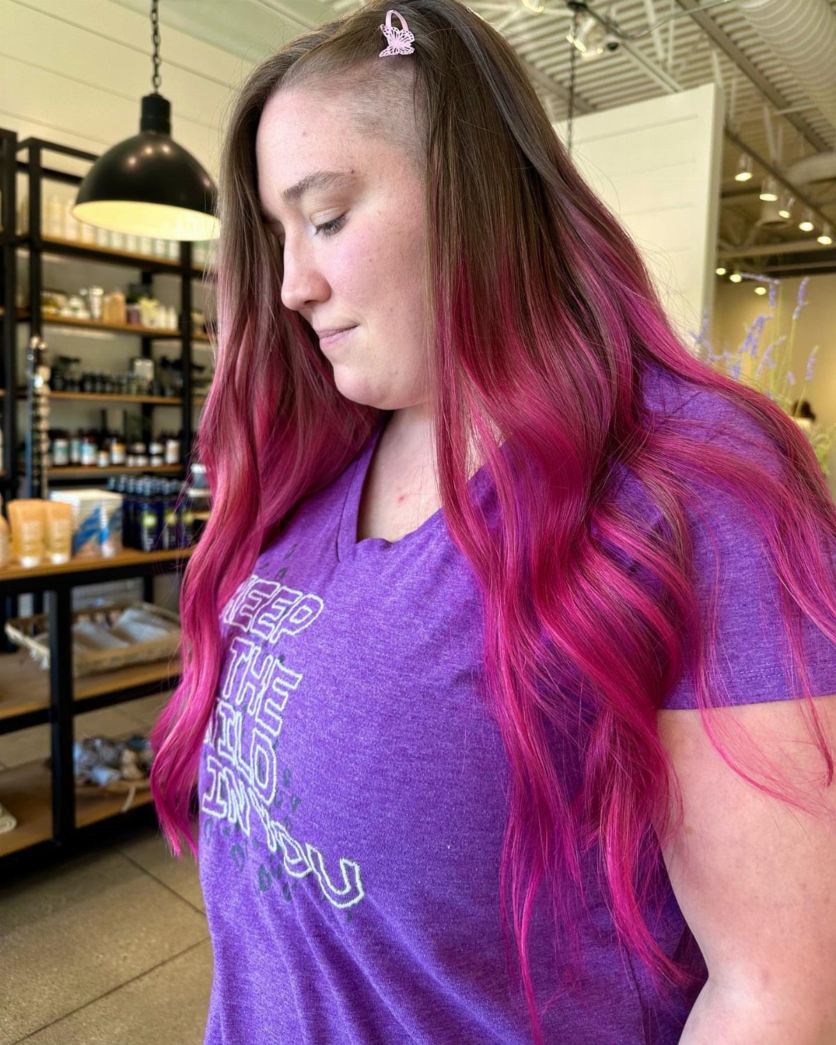 Young woman with long brown hair streaked with vivid pink and purple