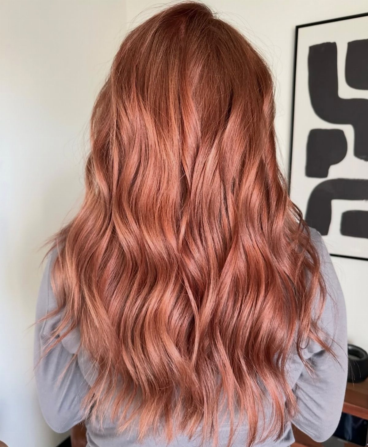 Wavy copper-red hair with strawberry-blonde woven highlights viewed from behind