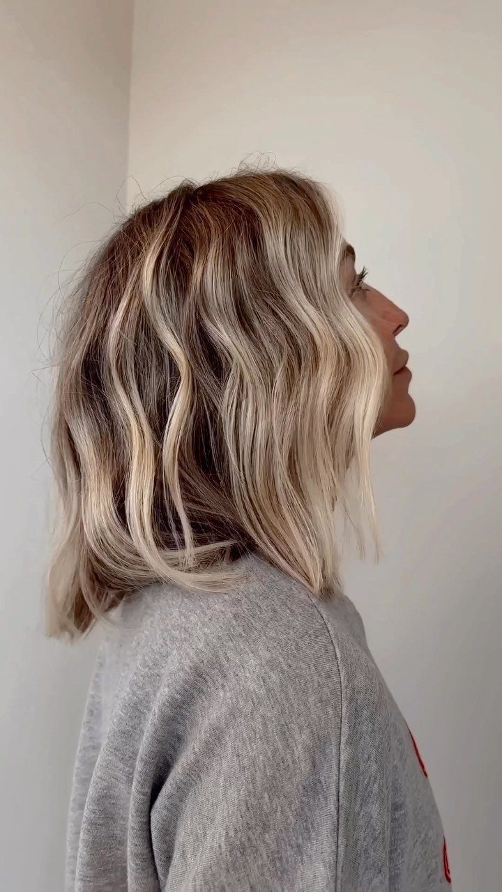 Shoulder-length balayage bob with dark roots and blonde waves
