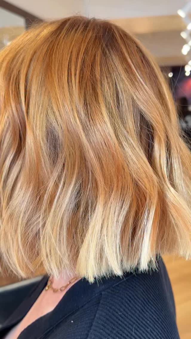 Strawberry blonde hair with soft, blended blonde balayage highlights and darker roots