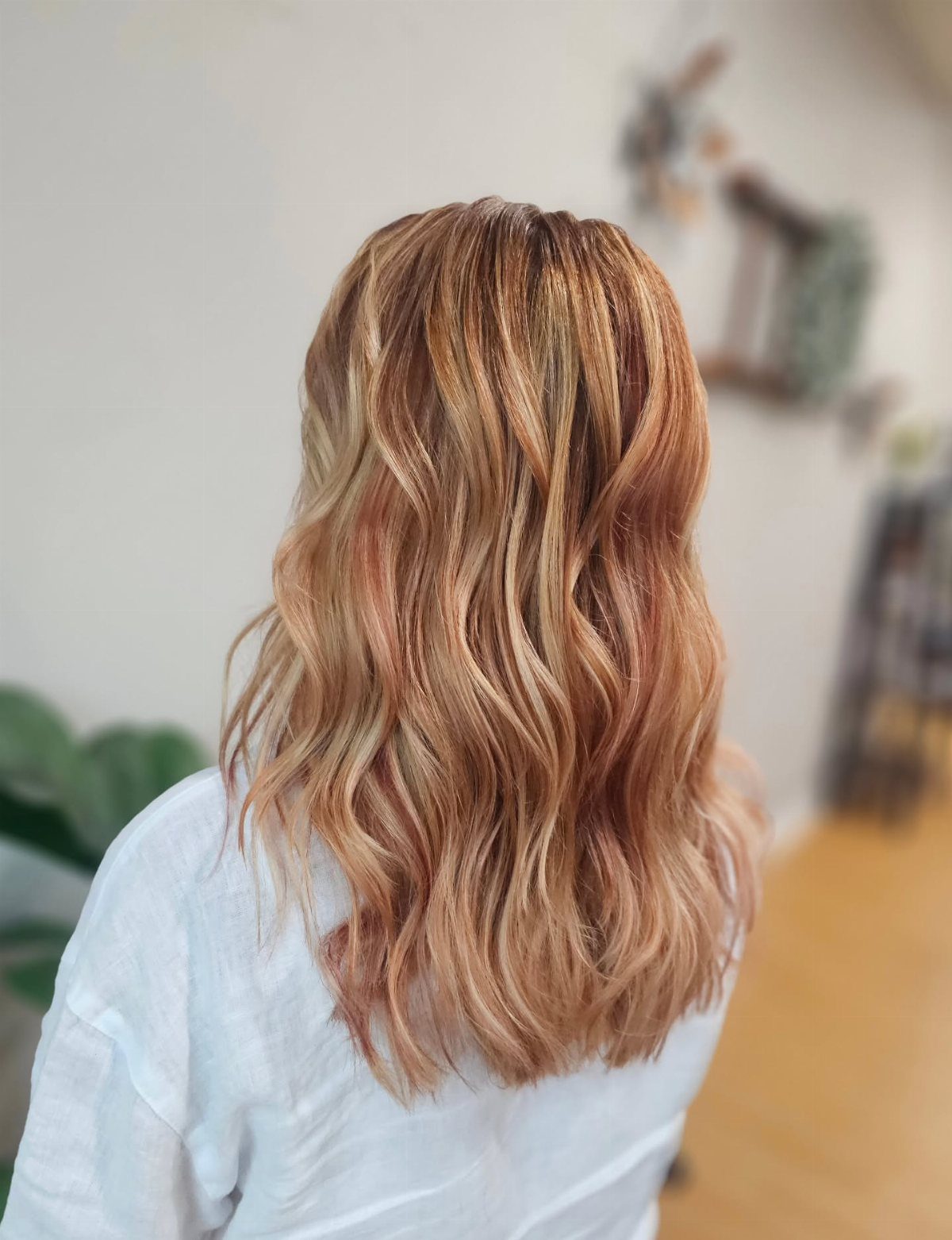 Wavy strawberry-blonde hair with warm rose and copper tones shown from behind